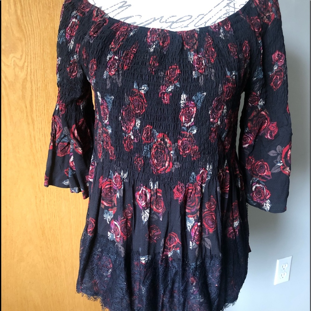 Red roses and black laced women’s top with elastic bodice.